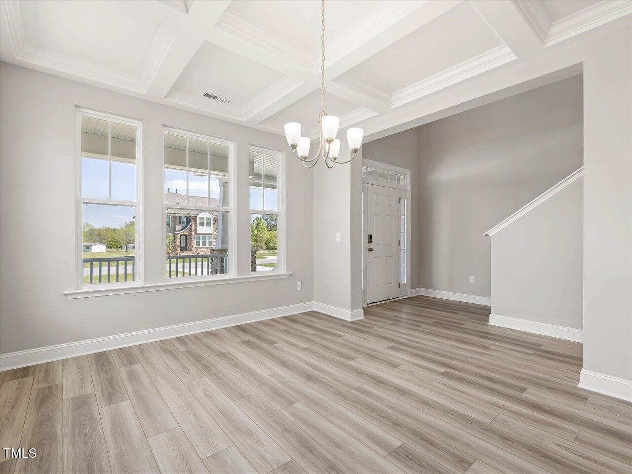 63 Biscayne Court Angier, NC 27501 - Photo 10 of 52 a view of an empty room with wooden floor and a window