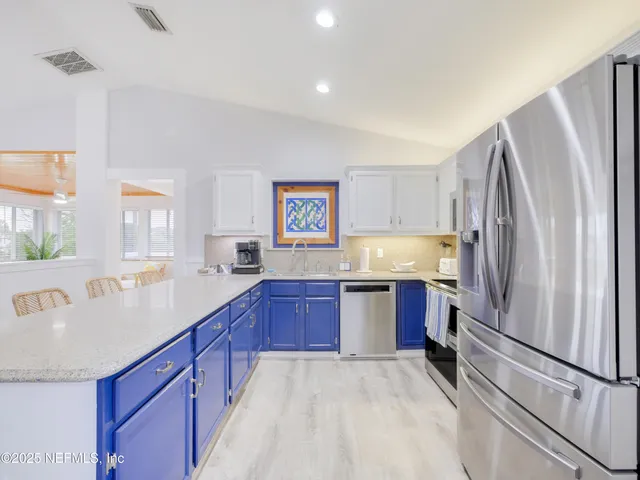 a kitchen with stainless steel appliances a refrigerator and a sink