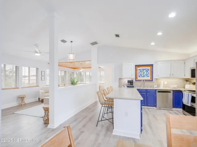 a living room with kitchen island granite countertop furniture and a kitchen view