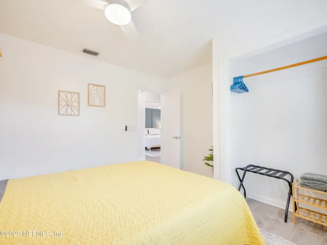 a bedroom with a bed and a chair