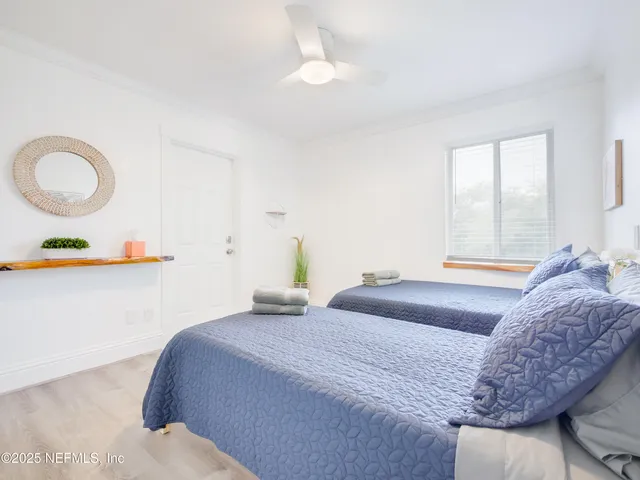 a bedroom with a bed and a painting on the wall