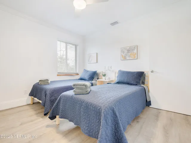 a bedroom with a bed and a night stand