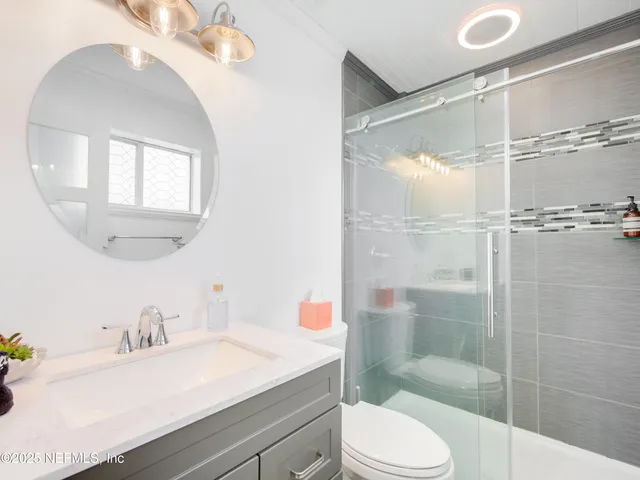 a bathroom with a sink toilet and shower