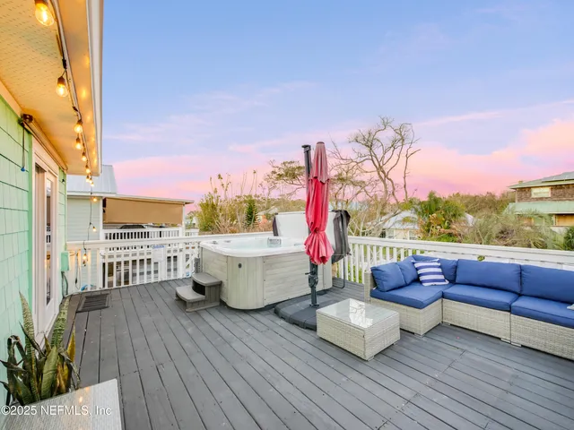 a swimming pool with outdoor seating and wooden floor