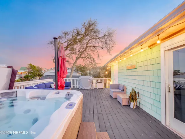a view of a balcony with couch and wooden floor