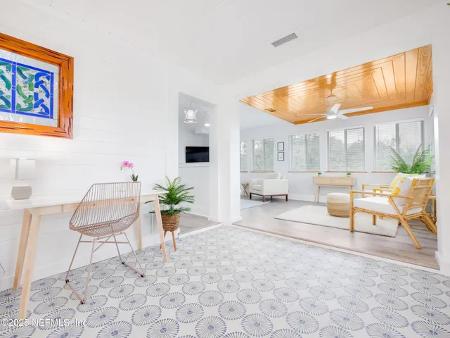 a living room with furniture and next to a window
