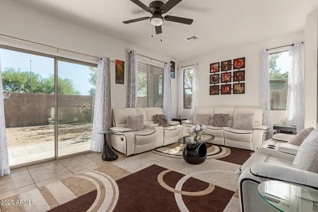a living room with furniture and a floor to ceiling window