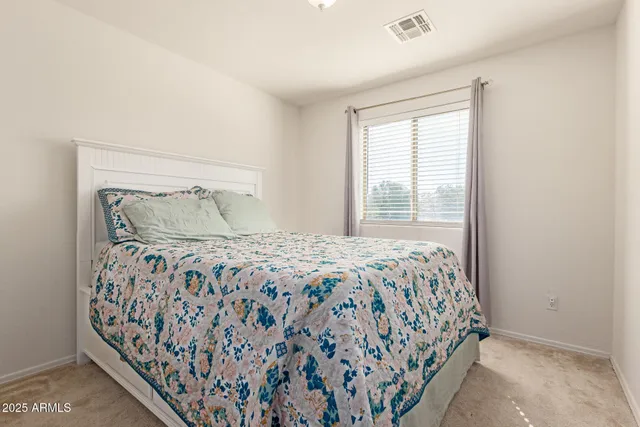 a bedroom with a large bed and a window