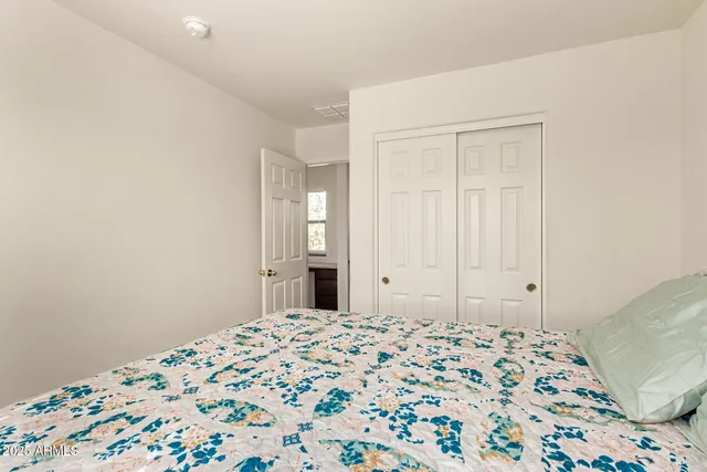 a bedroom with bed and cupboard