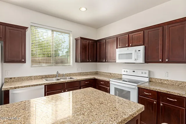 a kitchen with a stove sink and cabinets