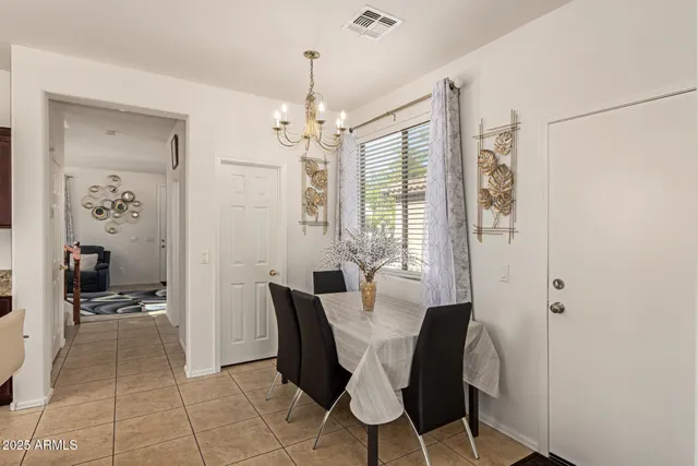 a view of a dining room with furniture and a chandelier