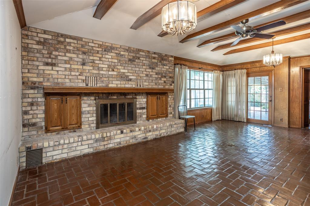 1010 Aspen Road Gainesville, TX 76240 - Photo 13 of 40 a view of an empty room with wooden floor and a window