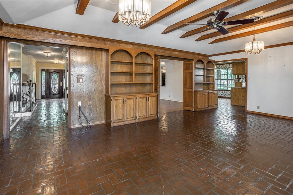 1010 Aspen Road Gainesville, TX 76240 - Photo 19 of 40 a view of an entryway with wooden floor and chandelier