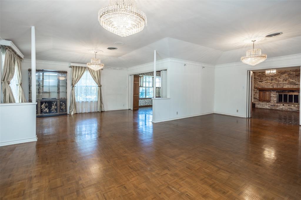 1010 Aspen Road Gainesville, TX 76240 - Photo 20 of 40 an empty room with wooden floor fireplace and windows