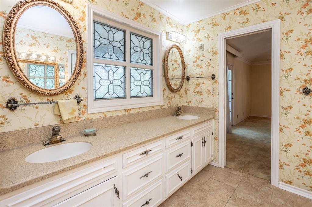 1010 Aspen Road Gainesville, TX 76240 - Photo 36 of 40 a bathroom with a sink double vanity and a mirror