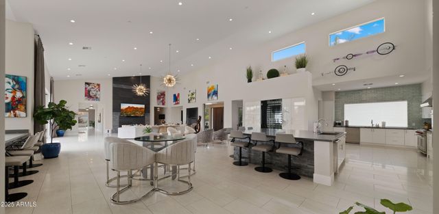 a bedroom with a bed a lamp potted plant and a lamp on dresser
