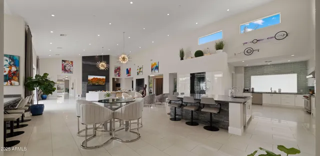 a bedroom with a bed a lamp potted plant and a lamp on dresser