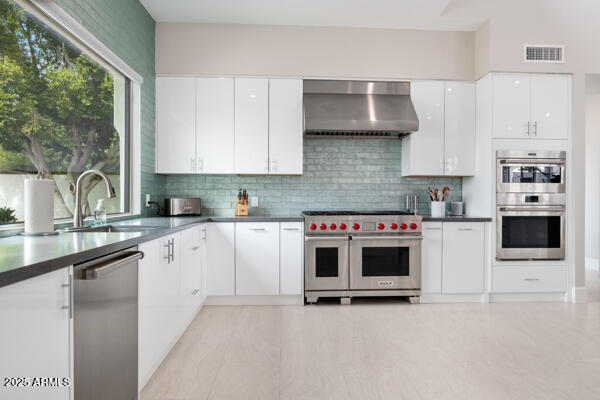 4425 North Arcadia Lane Phoenix, AZ 85018 - Photo 25 of 138 a kitchen with stainless steel appliances a stove a sink and a microwave