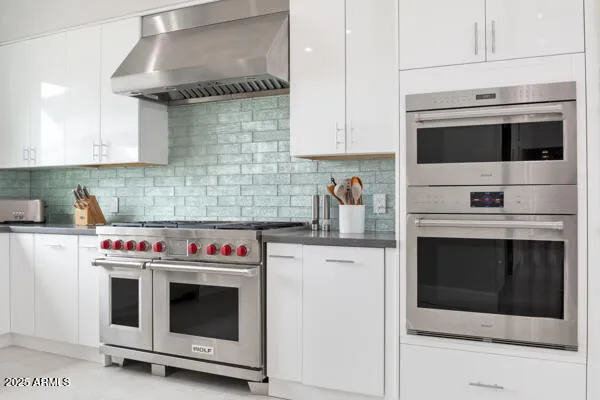 a bedroom with a large bed and a couch