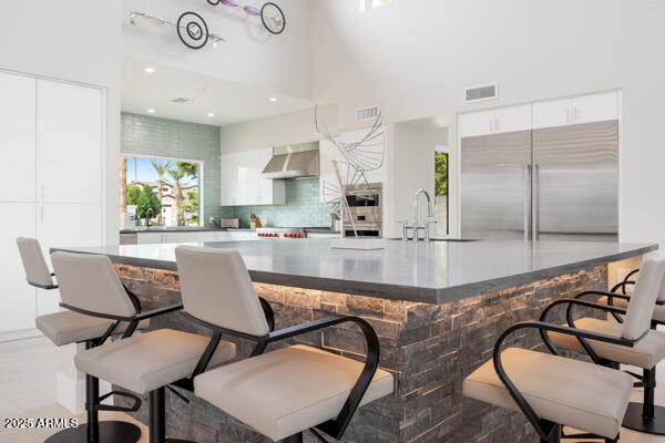 4425 North Arcadia Lane Phoenix, AZ 85018 - Photo 29 of 138 a kitchen with granite countertop a table chairs stove and a sink