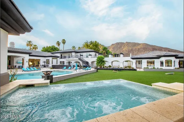 a living room with fireplace furniture and a chandelier