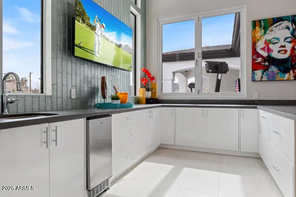a living room with furniture and a potted plant