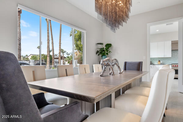 4425 North Arcadia Lane Phoenix, AZ 85018 - Photo 37 of 138 a view of a dining room with furniture window and wooden floor