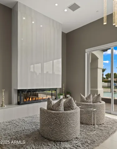 a view of a swimming pool with a lounge chair and floor to ceiling fan