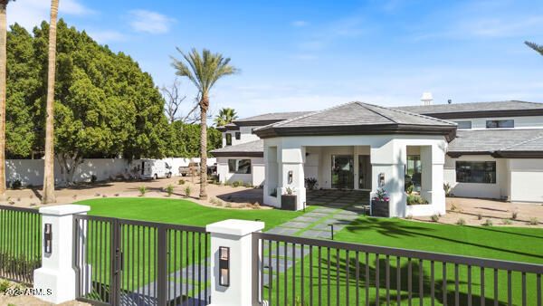 a living room with furniture a flat screen tv and a chandelier