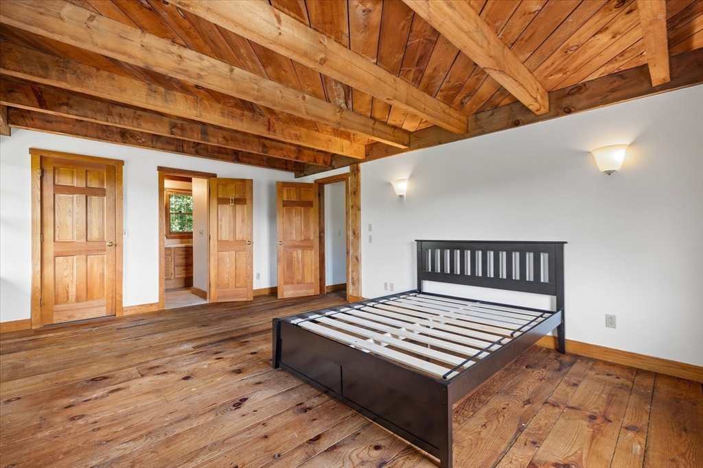 168 O'Neil Road West Warren, MA 01092 - Photo 14 of 42 a bedroom with a bed and wooden floor