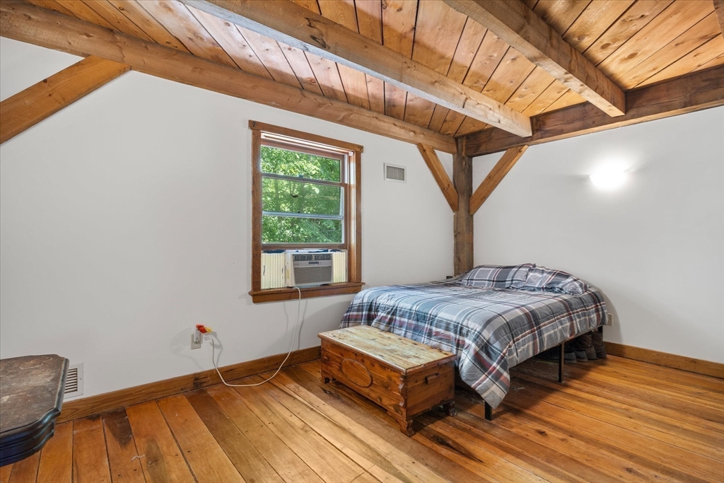 168 O'Neil Road West Warren, MA 01092 - Photo 17 of 42 a bedroom with a bed a mirror and a window