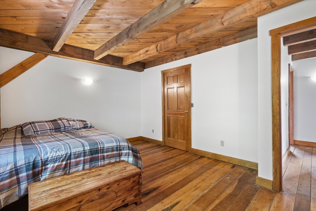168 O'Neil Road West Warren, MA 01092 - Photo 18 of 42 a bedroom with a bed and wooden floor
