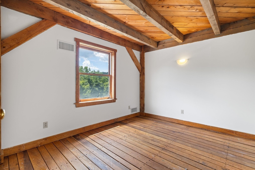 168 O'Neil Road West Warren, MA 01092 - Photo 19 of 42 a view of an empty room with wooden floor and a window