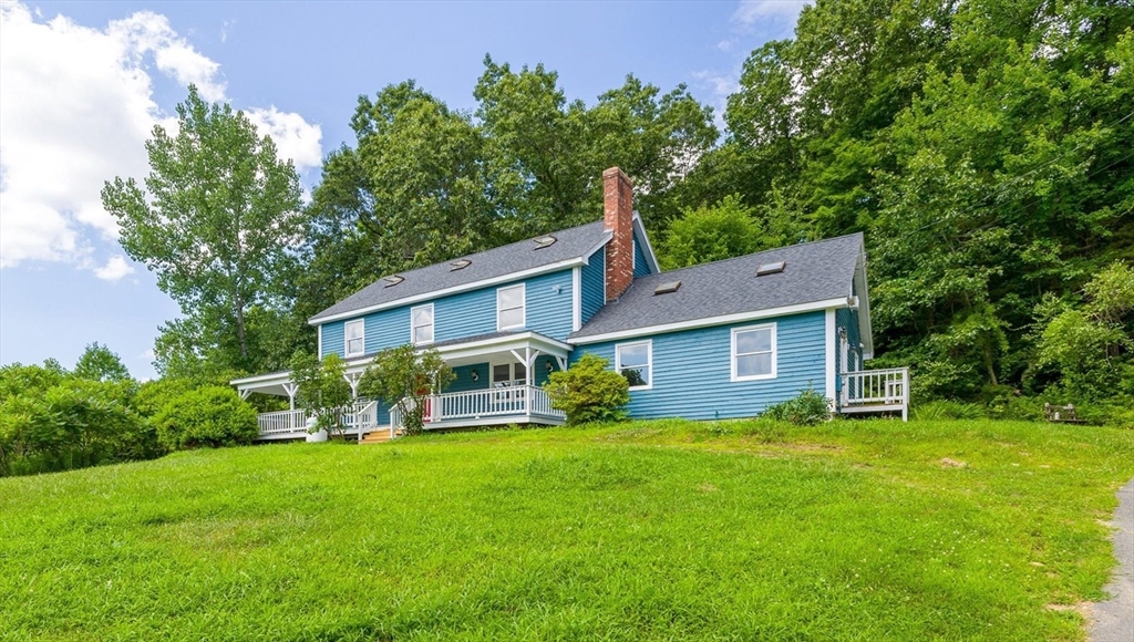 168 O'Neil Road West Warren, MA 01092 - Photo 2 of 42 a view of a house with a big yard and large trees