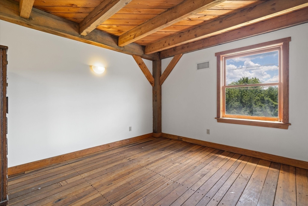 168 O'Neil Road West Warren, MA 01092 - Photo 21 of 42 a view of an empty room with wooden floor and a window