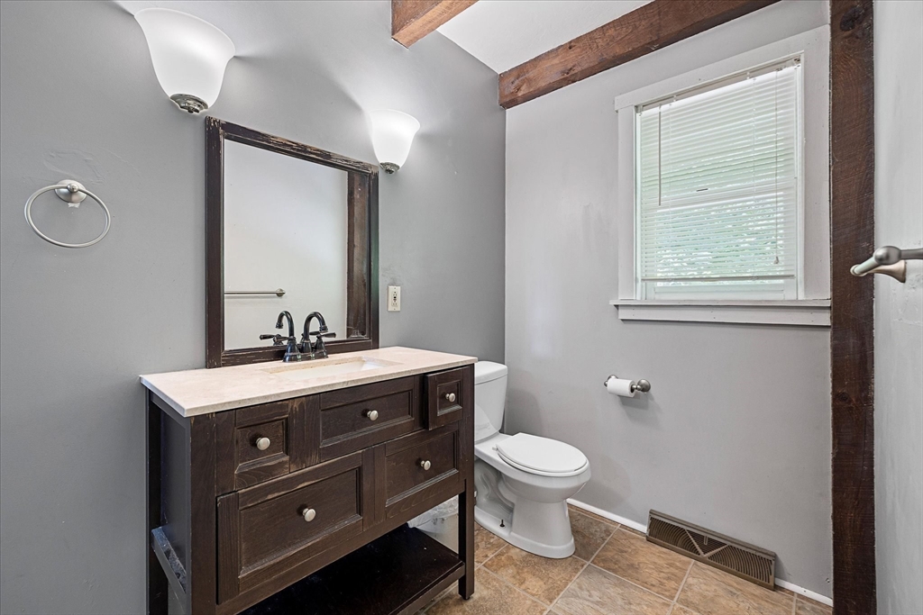 168 O'Neil Road West Warren, MA 01092 - Photo 36 of 42 a bathroom with a toilet a sink a mirror a window and vanity