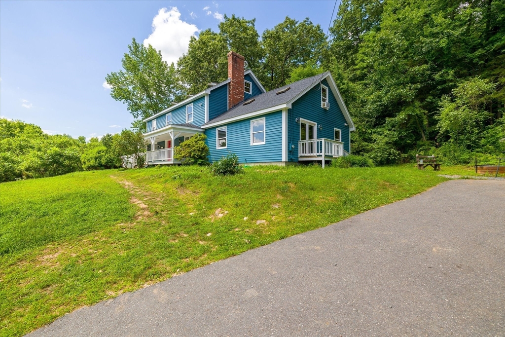 168 O'Neil Road West Warren, MA 01092 - Photo 4 of 42 a front view of a house with yard and green space