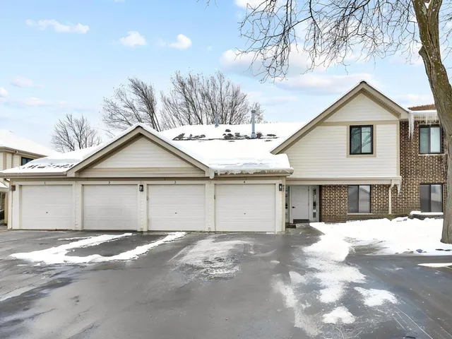 a view of a house with a yard covered in snow