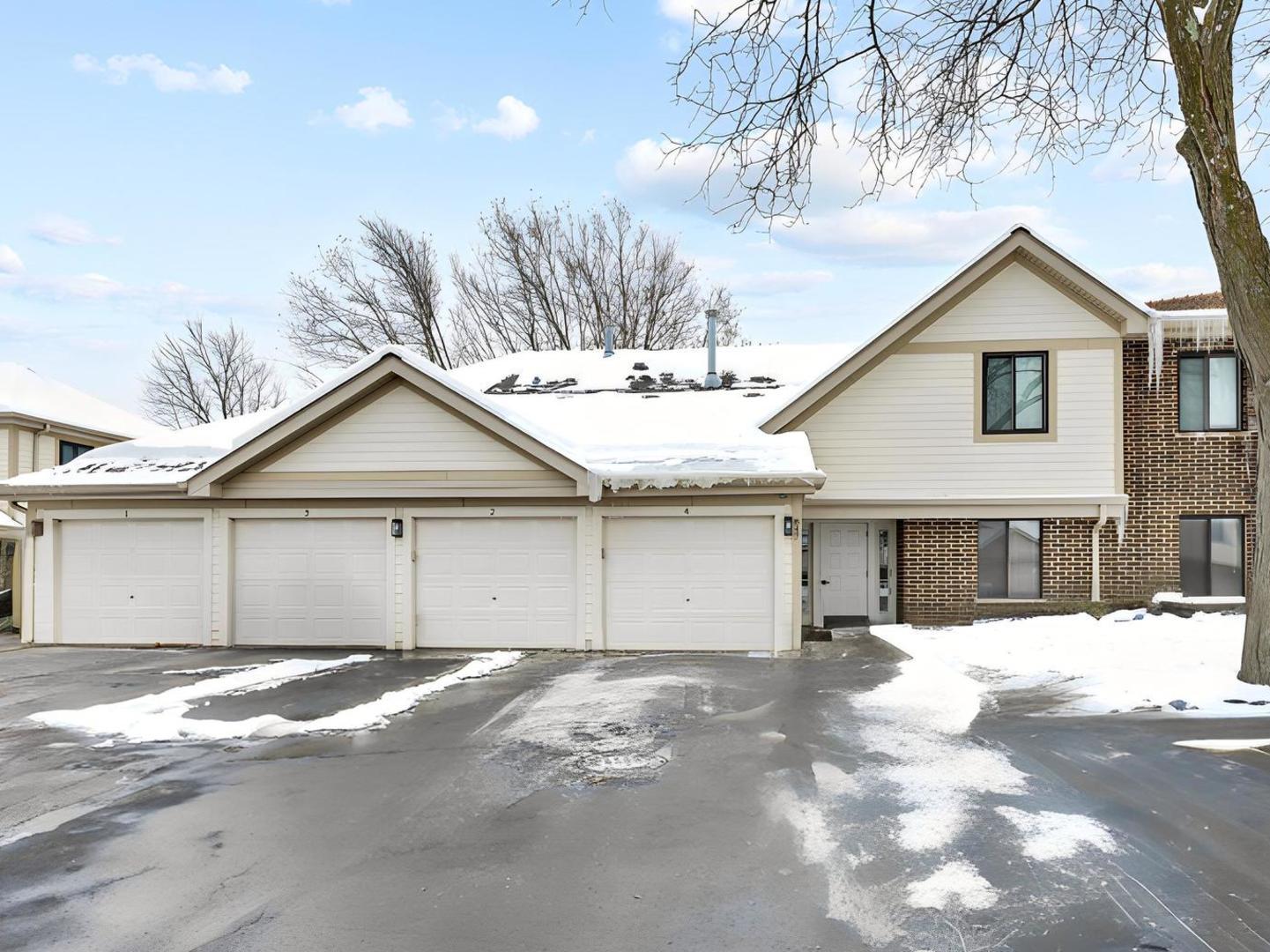 a view of a house with a yard covered in snow