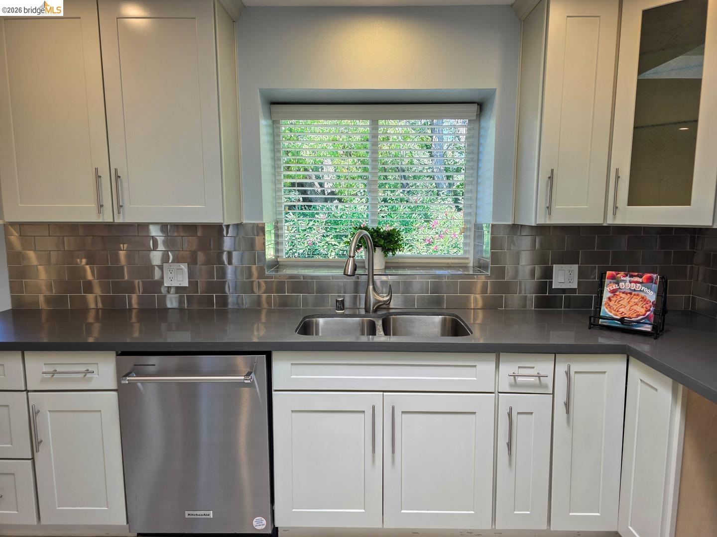 965 Springer Road Los Altos, CA 94024 - Photo 15 of 31 Modern kitchen featuring white shaker cabinetry, stainless steel subway tile backsplash, and dark countertops