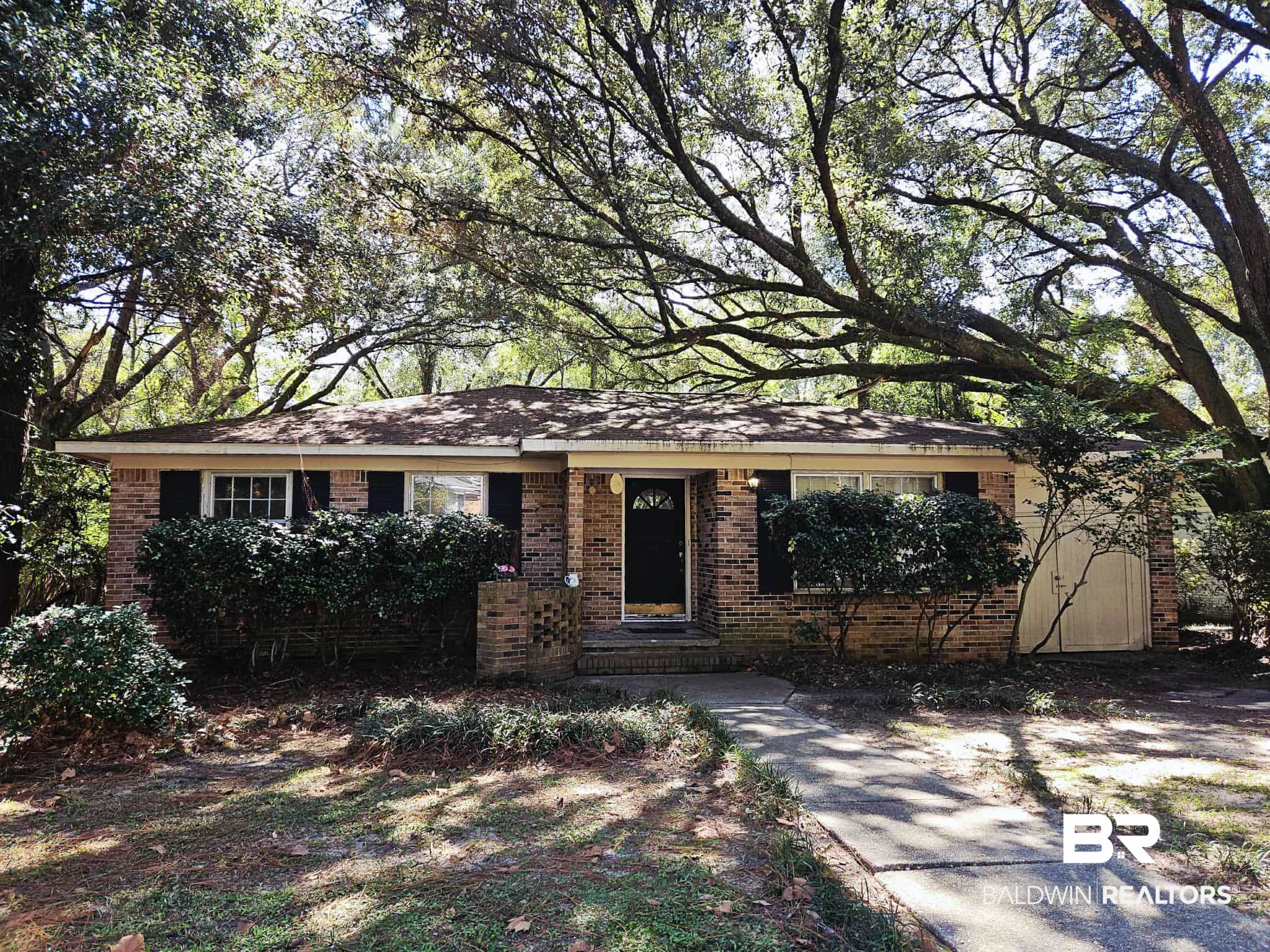 Single story home featuring brick siding