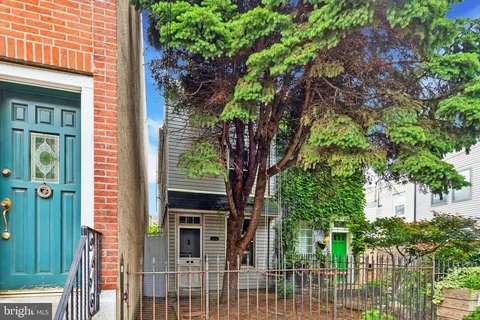 a tree in front of a house