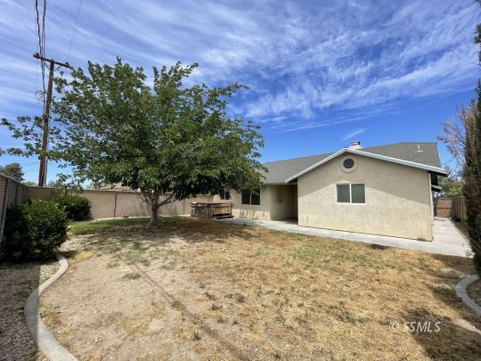 1133 West Benson Avenue Ridgecrest, CA 93555 - Photo 34 of 34 a white house that has a tree in front of it