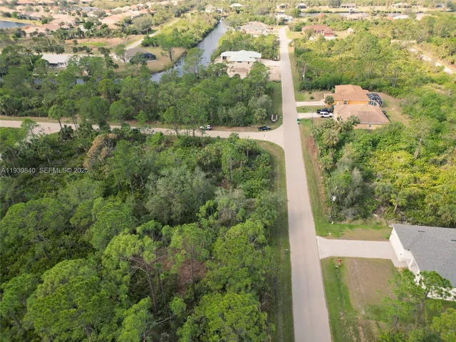 an aerial view of a house with yard