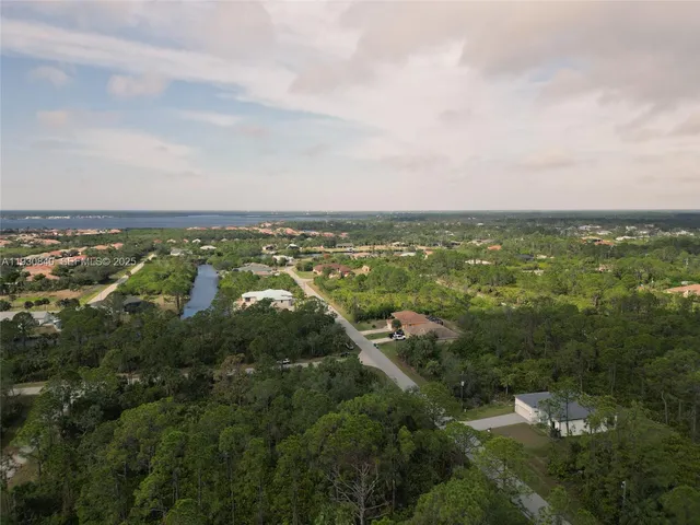 an aerial view of residential houses with outdoor space and swimming