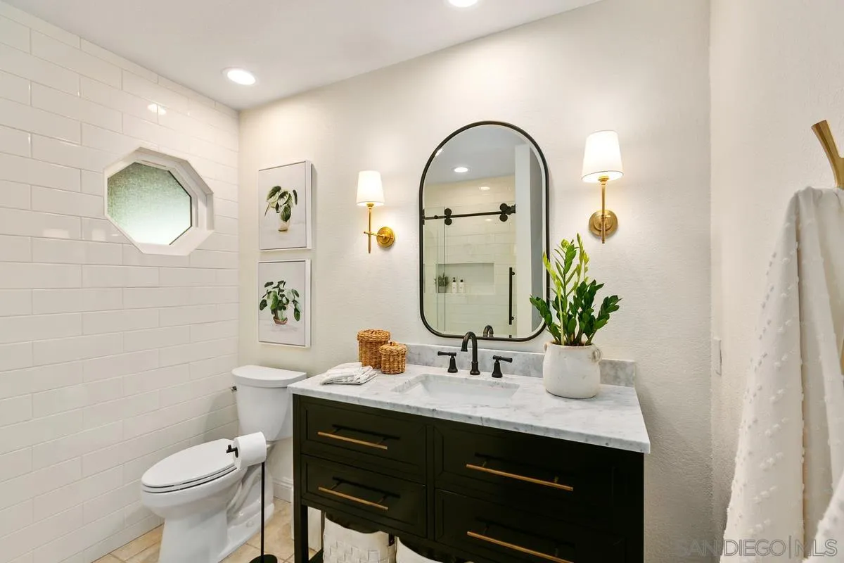 3330 Vista Rocosa Escondido, CA 92029 - Photo 17 of 29 a bathroom with a toilet a sink and a mirror