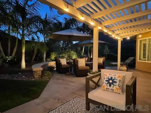 3330 Vista Rocosa Escondido, CA 92029 - Photo 28 of 29 a view of a patio with table and chairs under an umbrella with a fire pit and a patio