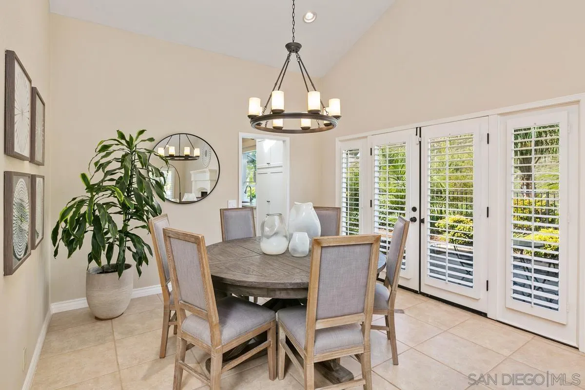 3330 Vista Rocosa Escondido, CA 92029 - Photo 7 of 29 a dining room with furniture a potted plant and a chandelier