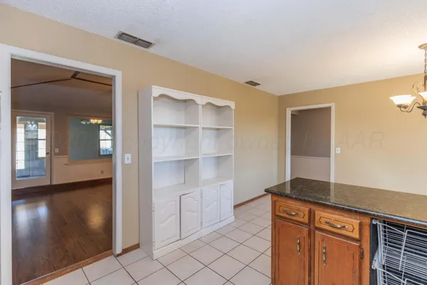 a kitchen with a sink window and cabinets