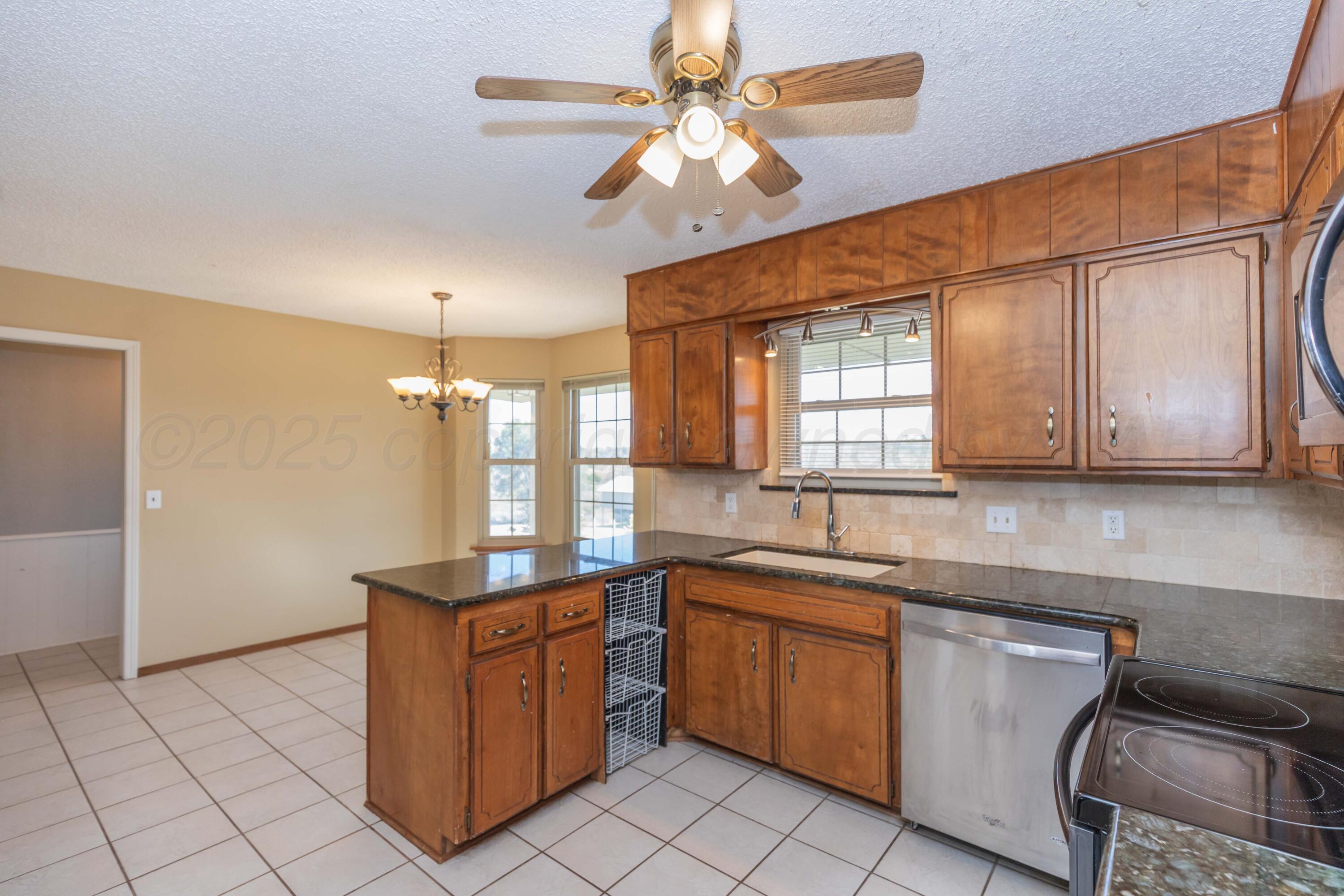 134 Eddie Street Canadian, TX 79014 - Photo 14 of 45 a kitchen with a sink window and cabinets